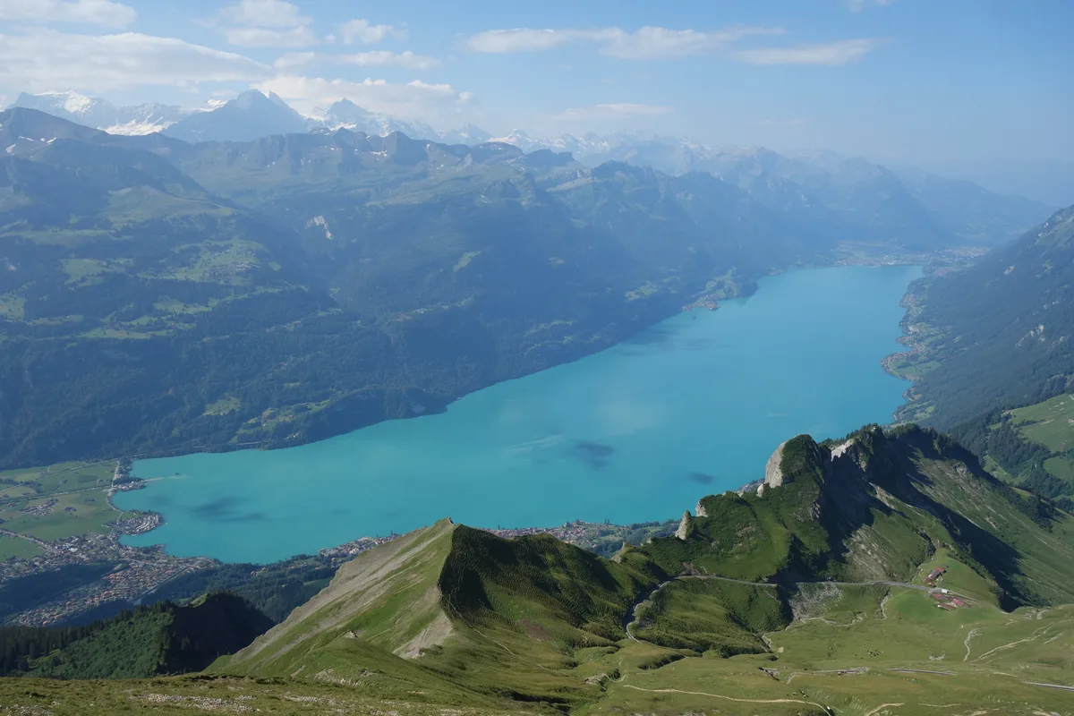 Blick vom Brienzer Rothorn über den türkisen Brienzersee, im Hintergrund die Kette der Berner Alpen