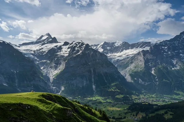 Panorama der Jungfrau Region mit Eiger, Mönch und Jungfrau über grünen Alpwiesen